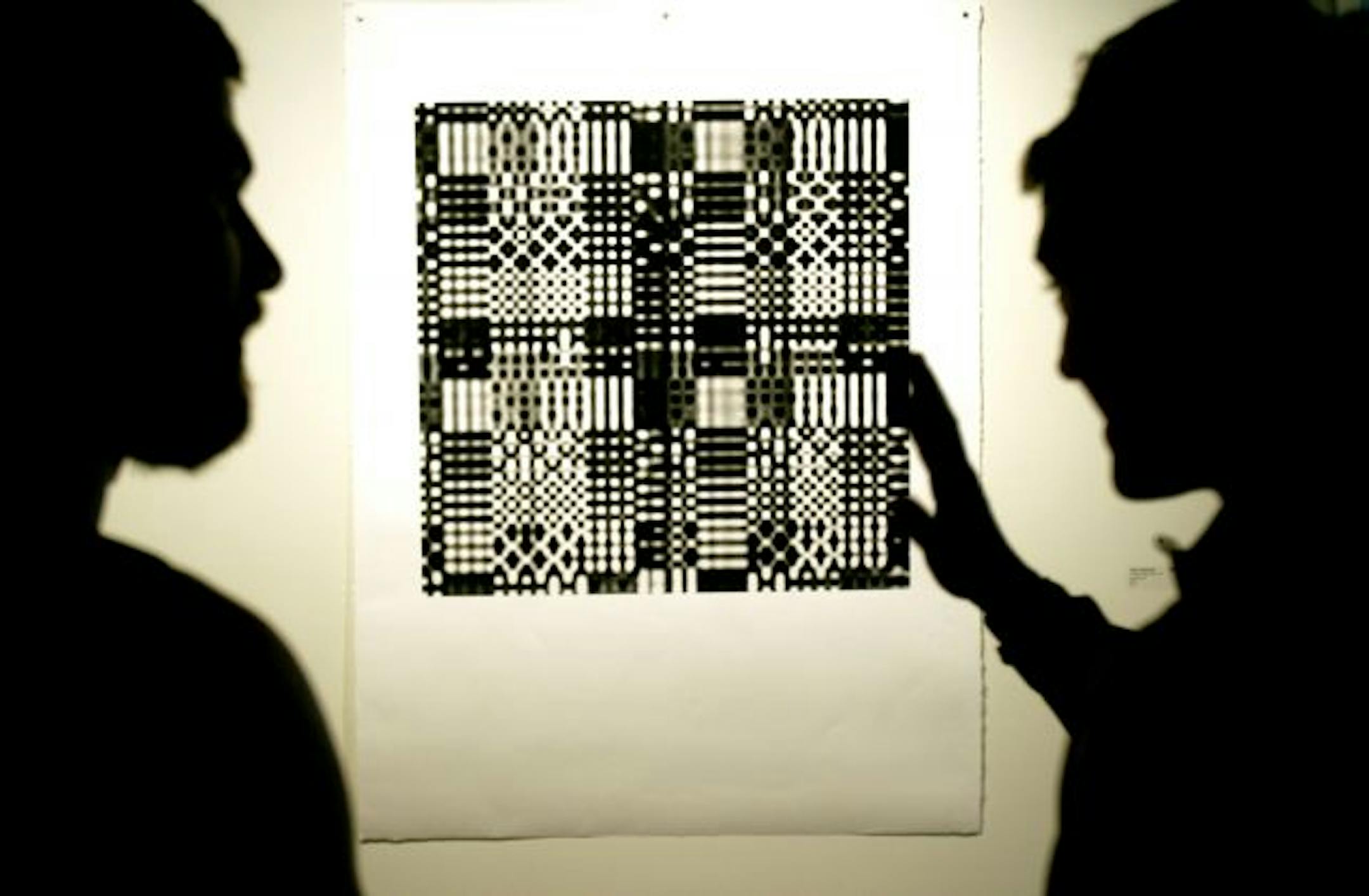 Miles Mendenhall, right, explained one of his prints to David Dresbach of Minneapolis during last month's gallery opening at Highpoint Center for Printmaking.