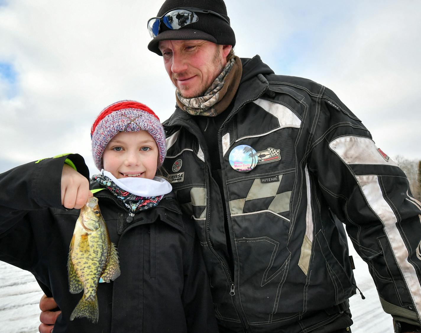 Troy Damyanovich brought his daughter Tayla to the 2017 Winter Frolic fishing contest on Carey Lake near Hibbing, where she caught the first fish of the day.