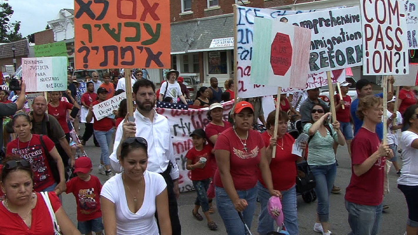 Along with Jewish activists, many immigrant workers joined the march in Postville, Iowa. Many female immigrants in the crowd wore electronic monitoring devices on their ankles as a result of the raid in May. Counterdemonstrators, above left, shouted slogans as the march advanced.