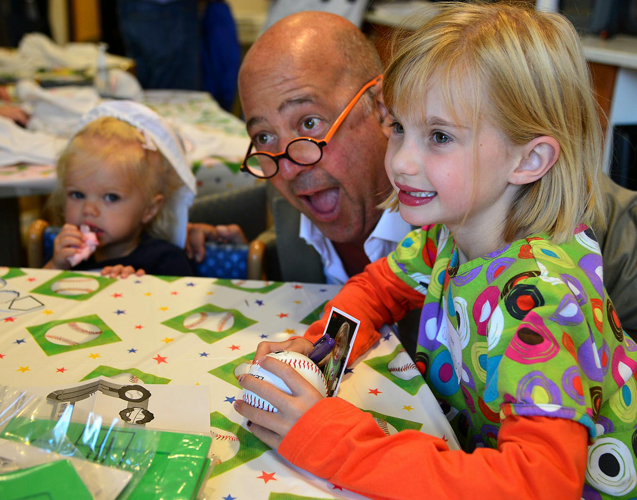 Andrew Zimmer television personality, chef, food writer, and teacher goofed for a picture with 2 year old Maggie Muller of Edina and her 7 year old sister Millie.
