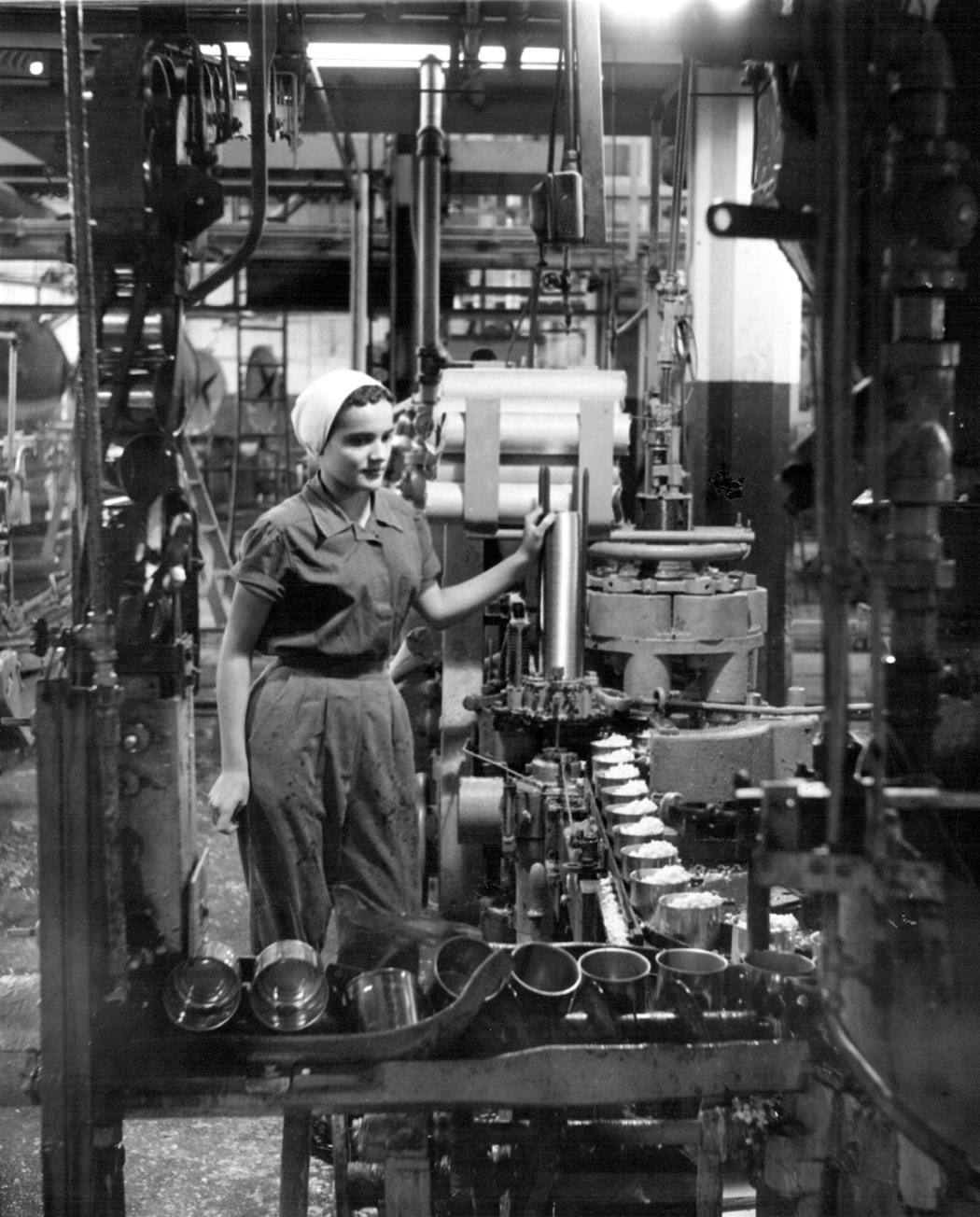 A worker in Le Sueur watched over corn coming off the Green Giant canning line in 1954.