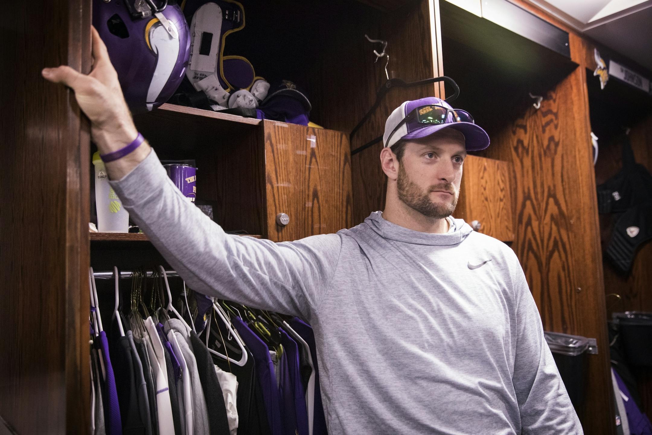 Brian Robison speaks with the media at his locker.