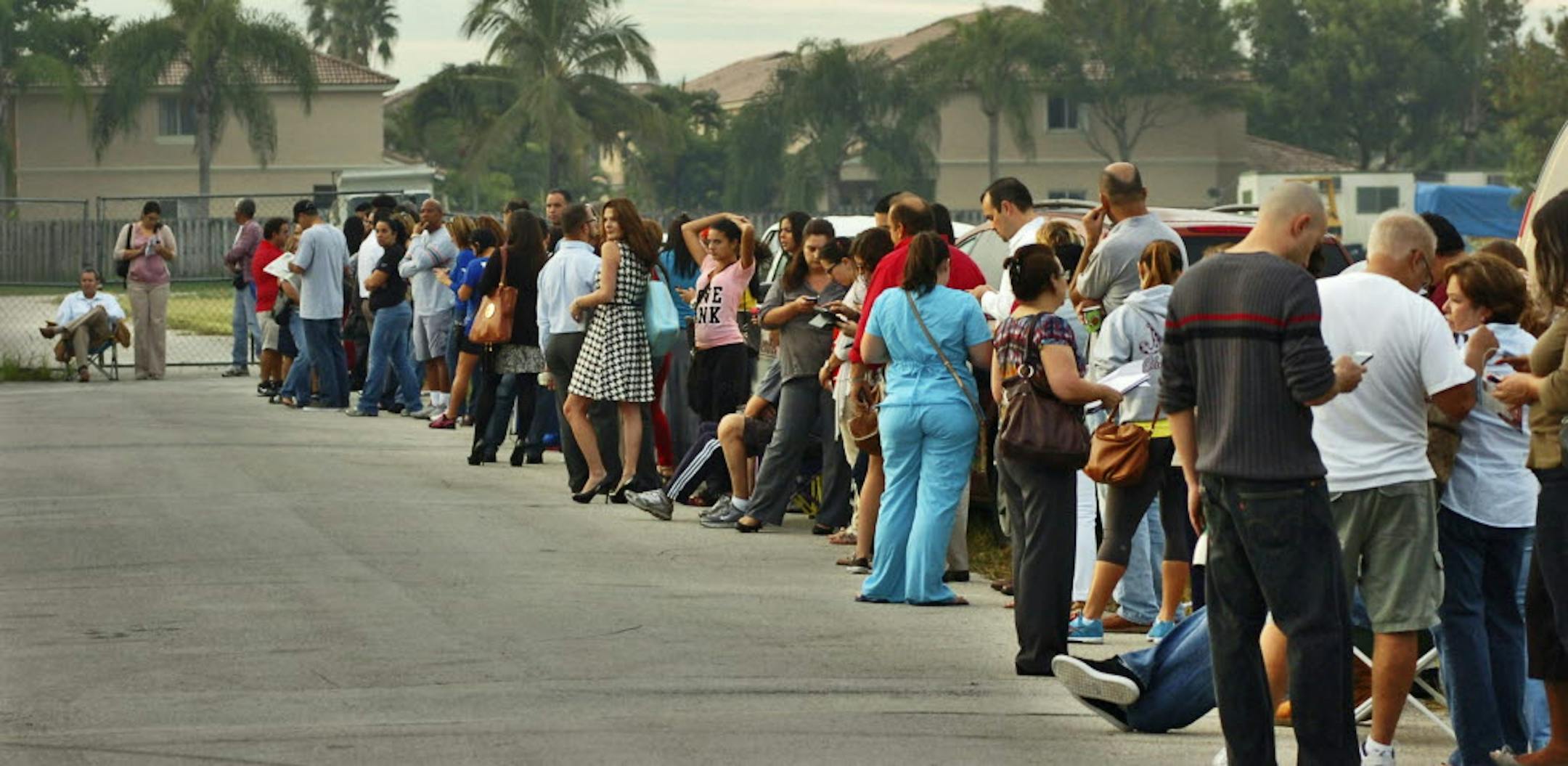 Voters wait in line tocast their ballots at a polling station, Tuesday, Nov. 6, 2012, in Miami.
