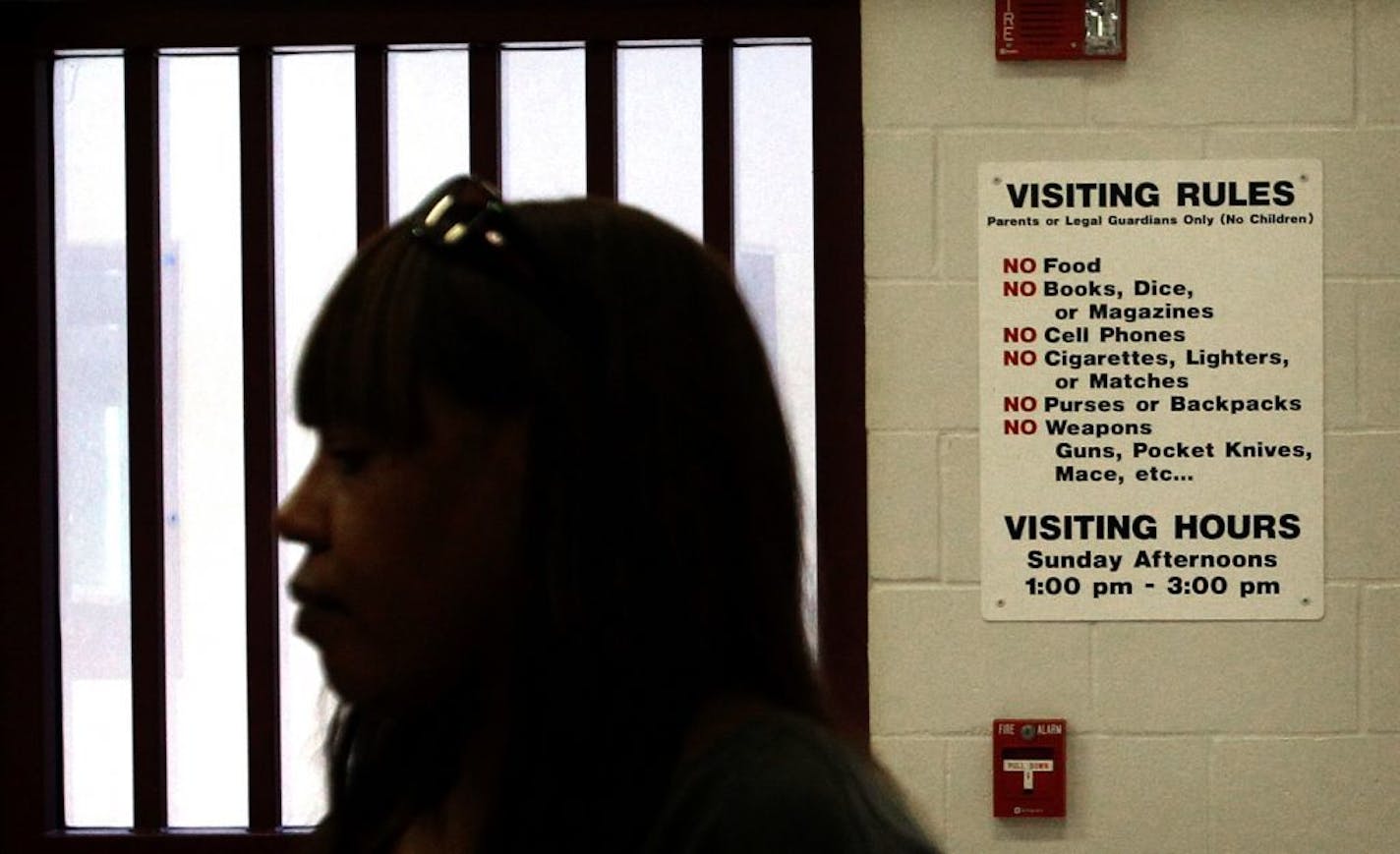 A sign posted inside Kohler Hall, a high level secure building at Totem Town School, advises visitors of rules they must adhere to. Theresa Neal (foreground) has gained national attention as the principal at Boys Totem Town school, a detention center for boys in St. Paul. Neal's husband, Villanova star basketball player Howard Porter, was murdered by two men five years ago.