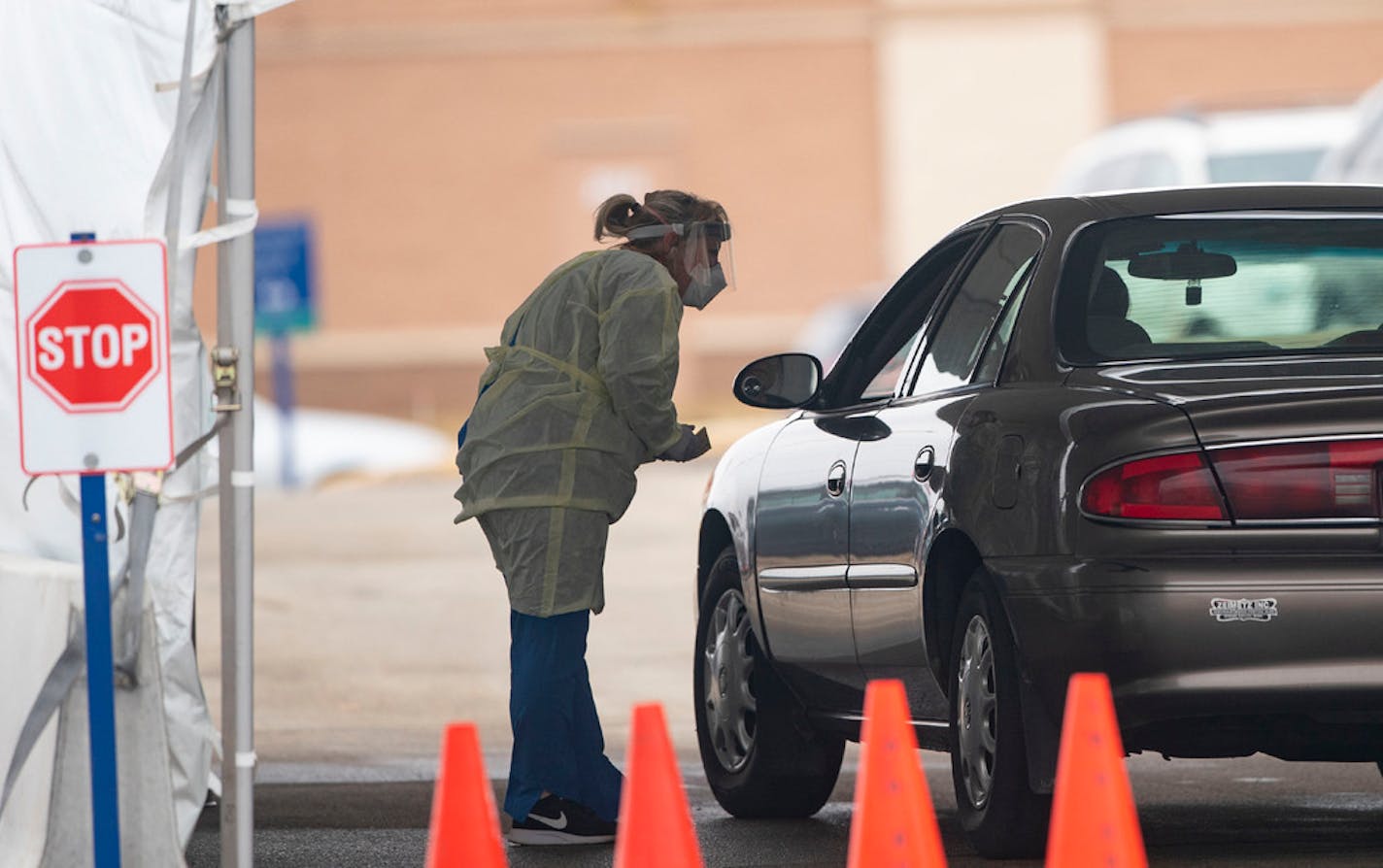 A Mayo Clinic employee in protective gear at a coronavirus testing site in the parking lot of the Mayo Family Clinic Northwest in Rochester, Minn.