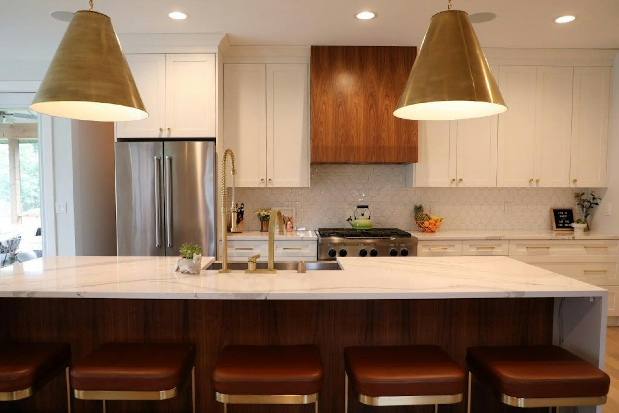 The updated kitchen features a mix of white and walnut cabinets.