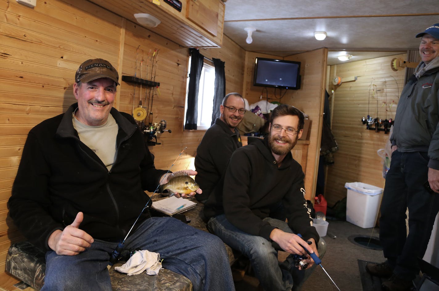 Frank Trcka, left, of Washington, Iowa, his nephew, Dan Auel of Mankato and Trcka's son-in-law, John Tebockhorst, of Washington, Iowa, are flanked on Lake Minnetonka by Todd Stauffer, right, owner of Set The Hook Guide Service and Fish House Rental. The three anglers spent three days on the ice, sleeping, eating and fishing, last week.