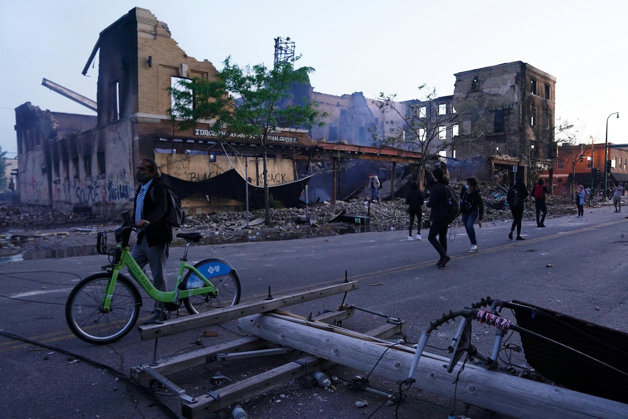 Protesters walked down East Lake Street after beating back a team of state troopers firing tear gas at them during another night of demonstrations over the death of George Floyd. ] ANTHONY SOUFFLE • anthony.souffle@startribune.com Police and community members braced for more demonstrations over the death of George Floyd in police custody as both Minneapolis and St. Paul, as well as Gov. Walz, issued curfews to try and curtail the looting and riots that have gone on all week Friday, May 29, 2020
