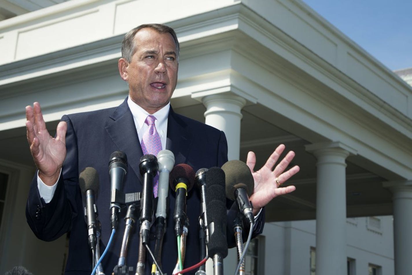 House Speaker John Boehner of Ohio speaks to reporters outside the White House in Washington in early September.