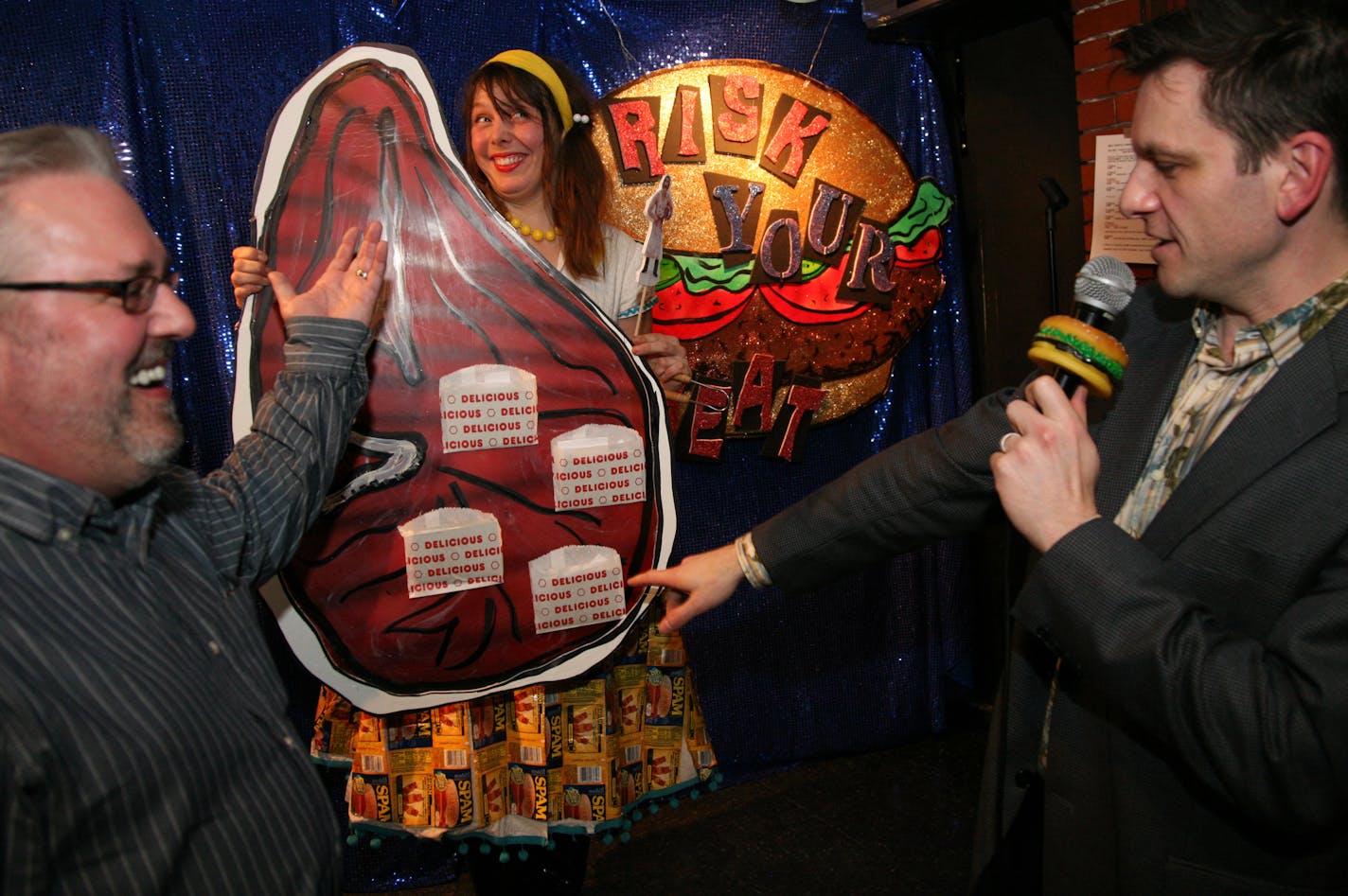 Rich Kronfeld and Faith Farrell put of the big meat and game show raffle at Grumpy�s Bar 1111 Washington Ave, Minneapolis, MN Saturday. The campy show gave away about 10 packages of meat to contestants that answered questions and played along with the game. Steve Sedahl, Plymouth, answer a question posed to him by Rich Kronfeld, Faith holds the prop