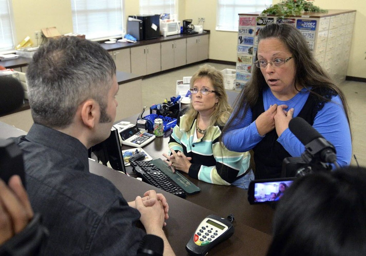 Rowan County Clerk Kim Davis, right, talks with David Moore following her office's refusal to issue marriage licenses at the Rowan County Courthouse in Morehead, Ky., Tuesday, Sept. 1, 2015. Although her appeal to the U.S. Supreme Court was denied, Davis still refuses to issue marriage licenses.