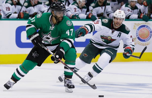 Dallas Stars defenseman Johnny Oduya (47) skates with the puck against Minnesota Wild right wing Jason Pominville (29)