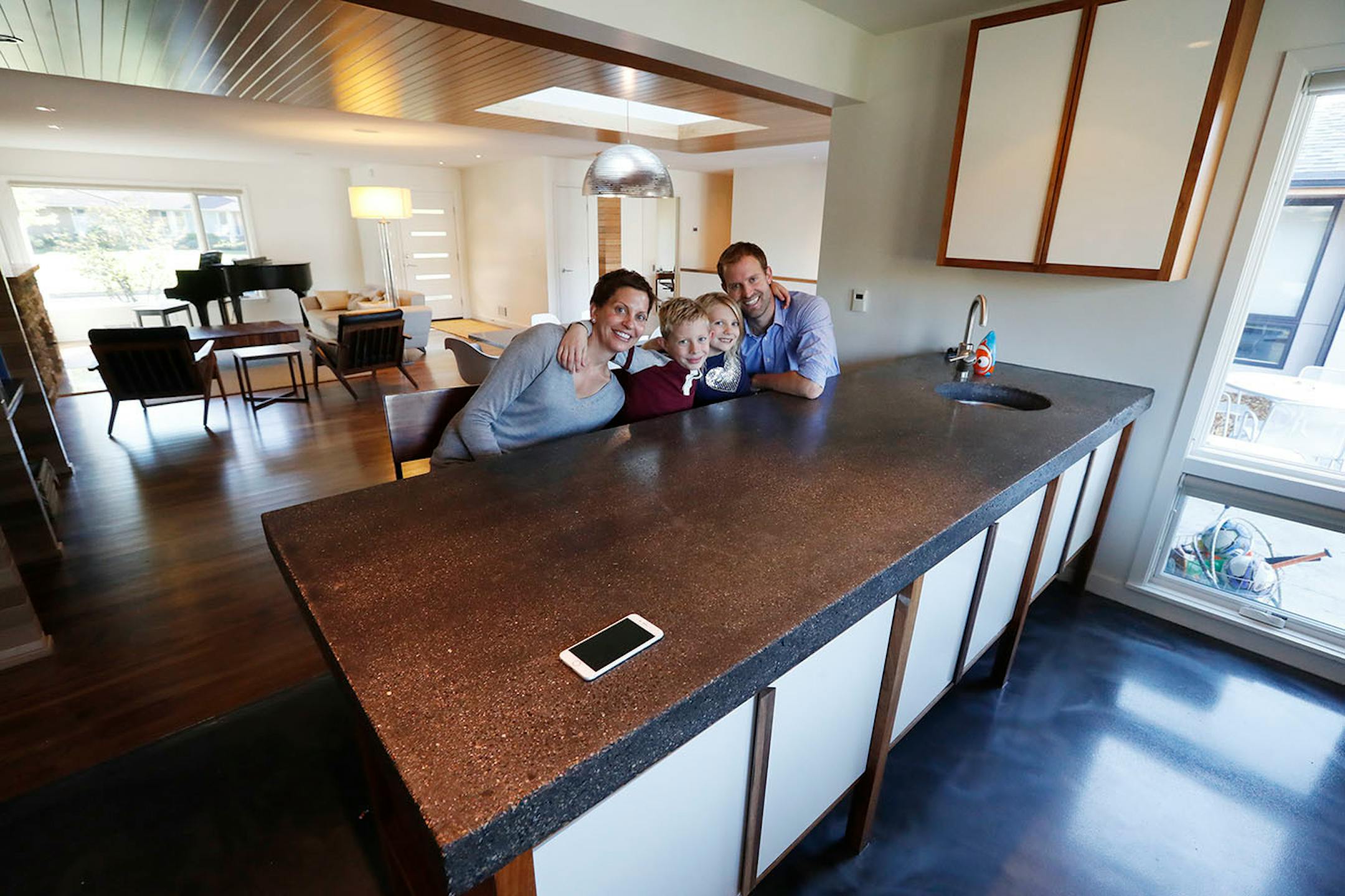 Homeowners Jill and Robert Prevost and their 6-year-old twins, Griffin and Siena, pose inside their revived 1950s rambler in St. Louis Park.