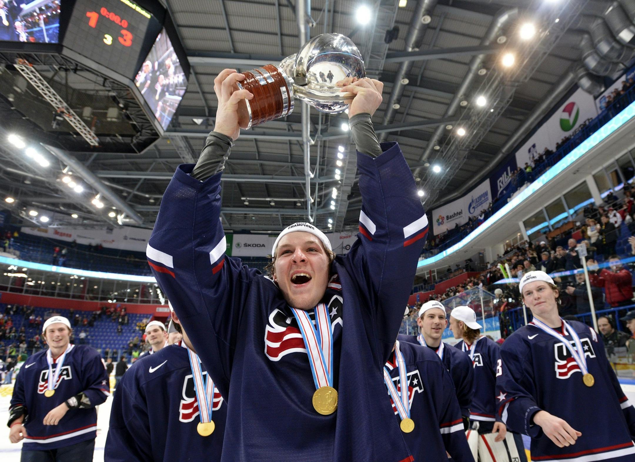 Team USA captain Jake McCabe hoists the World Junior trophy after his team defeated Sweden.