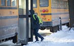 A student walked to his bus in the bitter cold after school at Sanford Middle School on Tuesday, January 16, 2018, in Minneapolis, Minn. Sanford and a