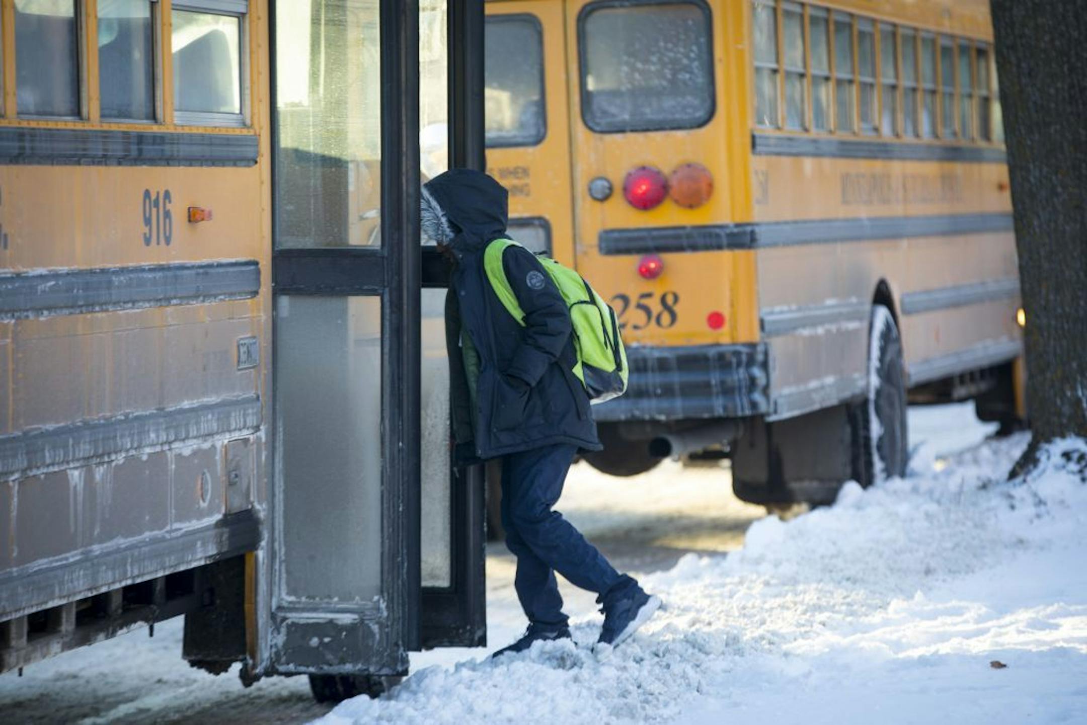 A student walked to his bus in the bitter cold after school at Sanford Middle School on Tuesday, January 16, 2018, in Minneapolis, Minn. Sanford and all other grades six through eight middle schools would be starting late at 9:30 a.m.