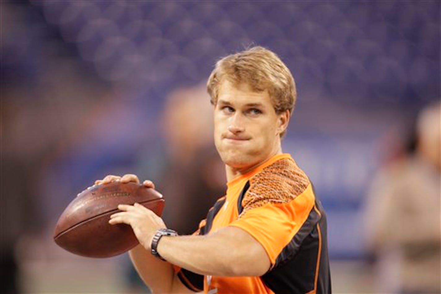 Michigan State quarterback Kirk Cousins throws a pass as he runs a drill at the NFL football scouting combine in Indianapolis, Sunday, Feb. 26, 2012. (AP Photo/Michael Conroy)