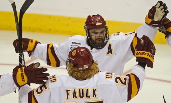 NCAA Frozen Four Semifinals, Minnesota Duluth vs Notre Dame. (left to right) Justin Faulk celebrated with Jack Connolly after Connolly scored a Bulldo