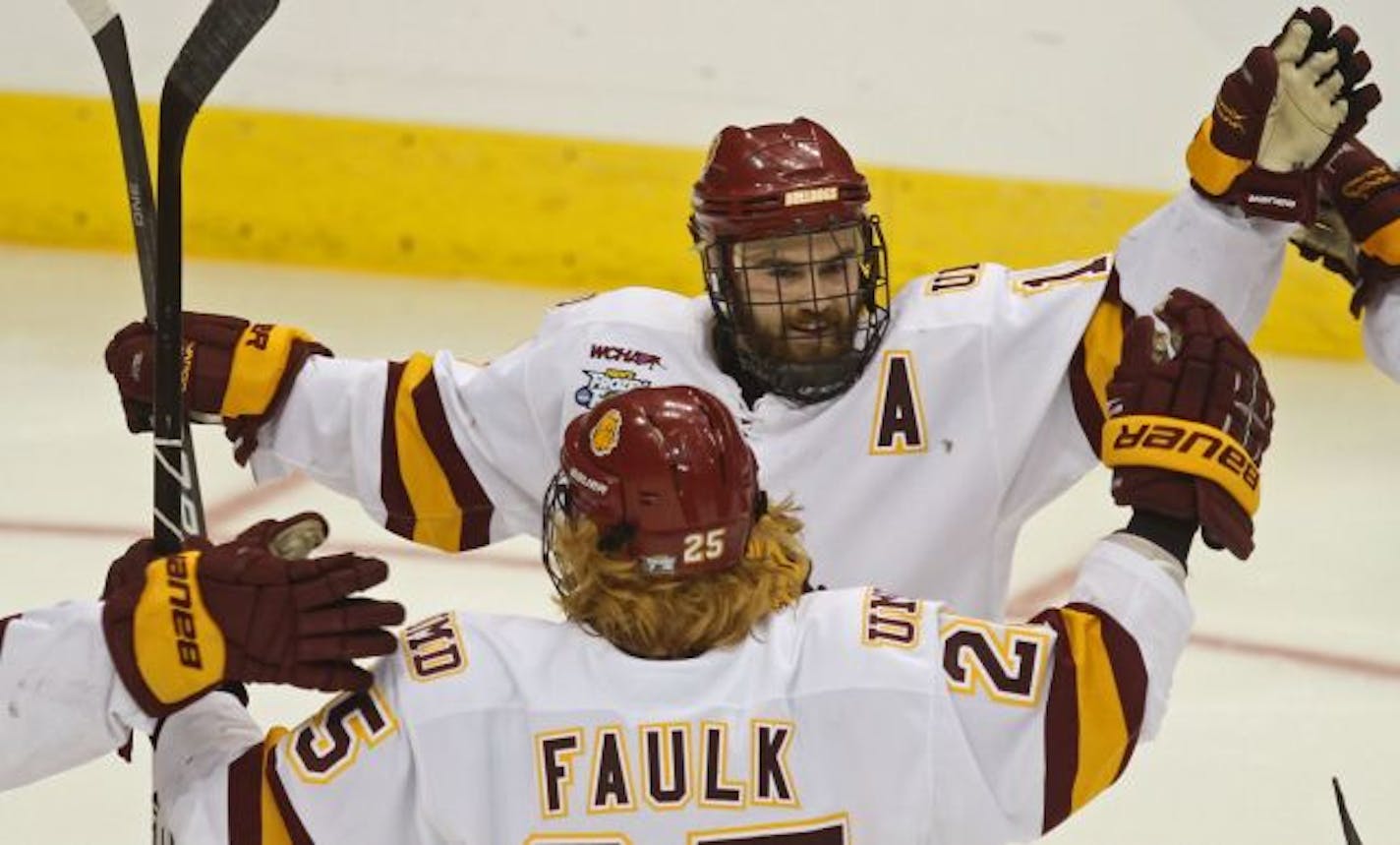 NCAA Frozen Four Semifinals, Minnesota Duluth vs Notre Dame. (left to right) Justin Faulk celebrated with Jack Connolly after Connolly scored a Bulldog goal against Notre Dame.