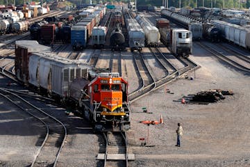 A BNSF rail terminal worker monitored the departure of a freight train in Galesburg, Ill., in 2021.