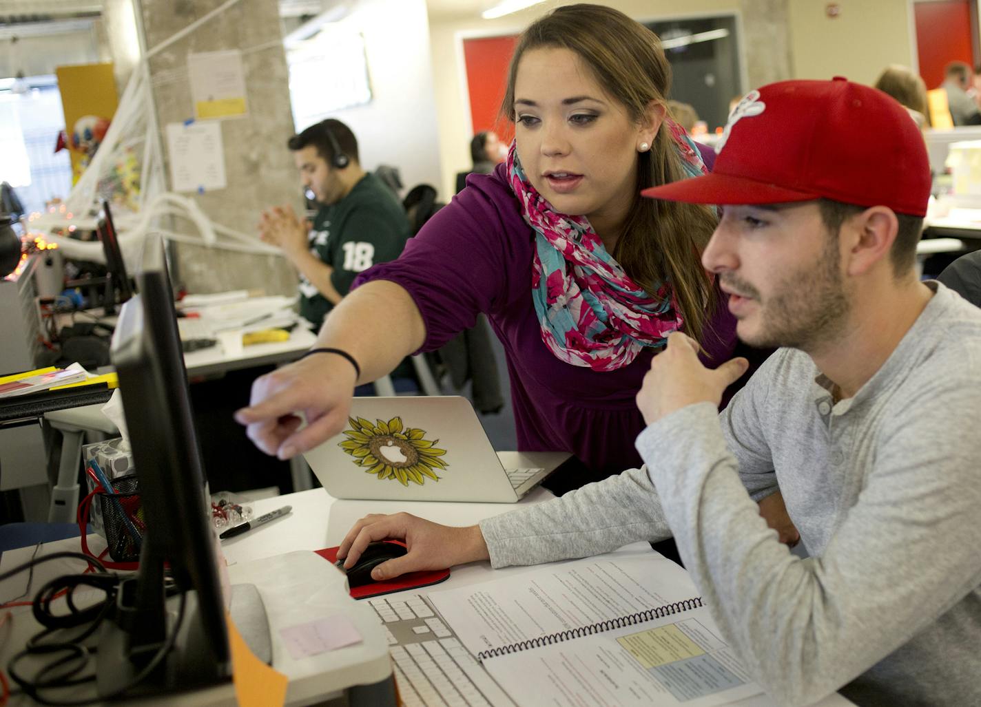 Martha Galewski, Associate Sales Training Manager, left, assists Yelp employee JD Hiudt, right, at the Yelp office located at Merchandise Mart on Oct. 16, 2015 in Chicago. (Kristen Norman/Chicago Tribune/TNS) ORG XMIT: 1182831