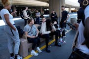 Players and staff of the New York Liberty wait to board buses at Harry Reid International Airport last season in Las Vegas. The wait for full-time cha