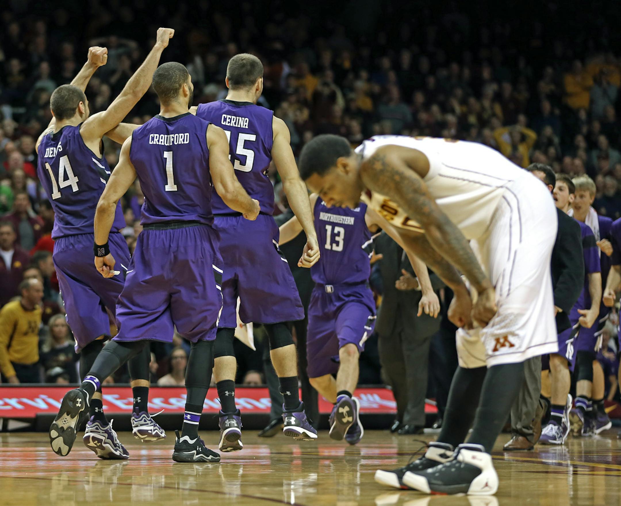 Northwestern players celebrated as Minnesota's Malik Smith slumped in dejection at the end of the game.
