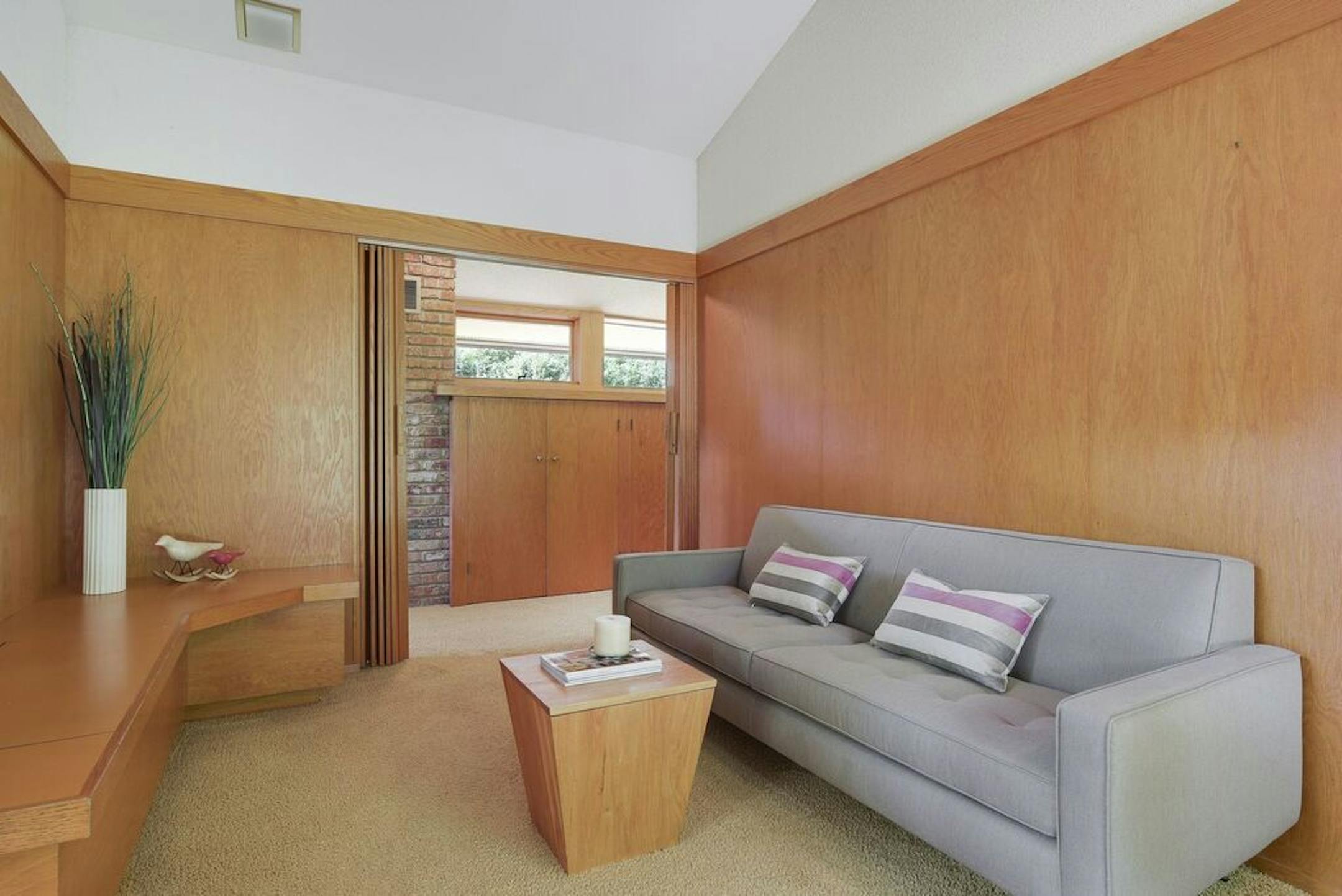 The wood-paneled den.