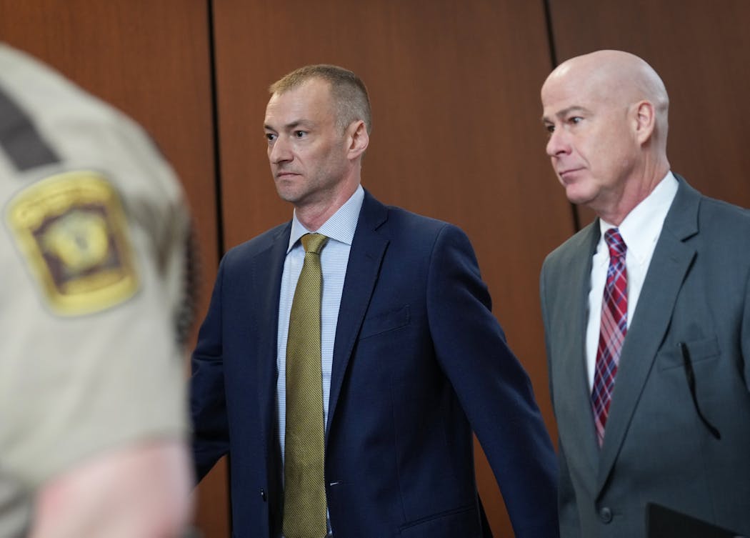 Former Minneapolis police officer Brian Cummings, left, and his attorney Tom Plunkett left a hearing at Hennepin County Government Center in Minneapolis on April 27.
