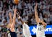 Nikola Jokic (15) of the Denver Nuggets is defended by Naz Reid (11) and Karl Anthony Towns (32) of the Timberwolves in the first quarter during Game 