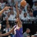 Timberwolves center Karl-Anthony Towns (32) passes the ball behind his head and past Suns center Jusuf Nurkic (20) and forward Kevin Durant (35) in th