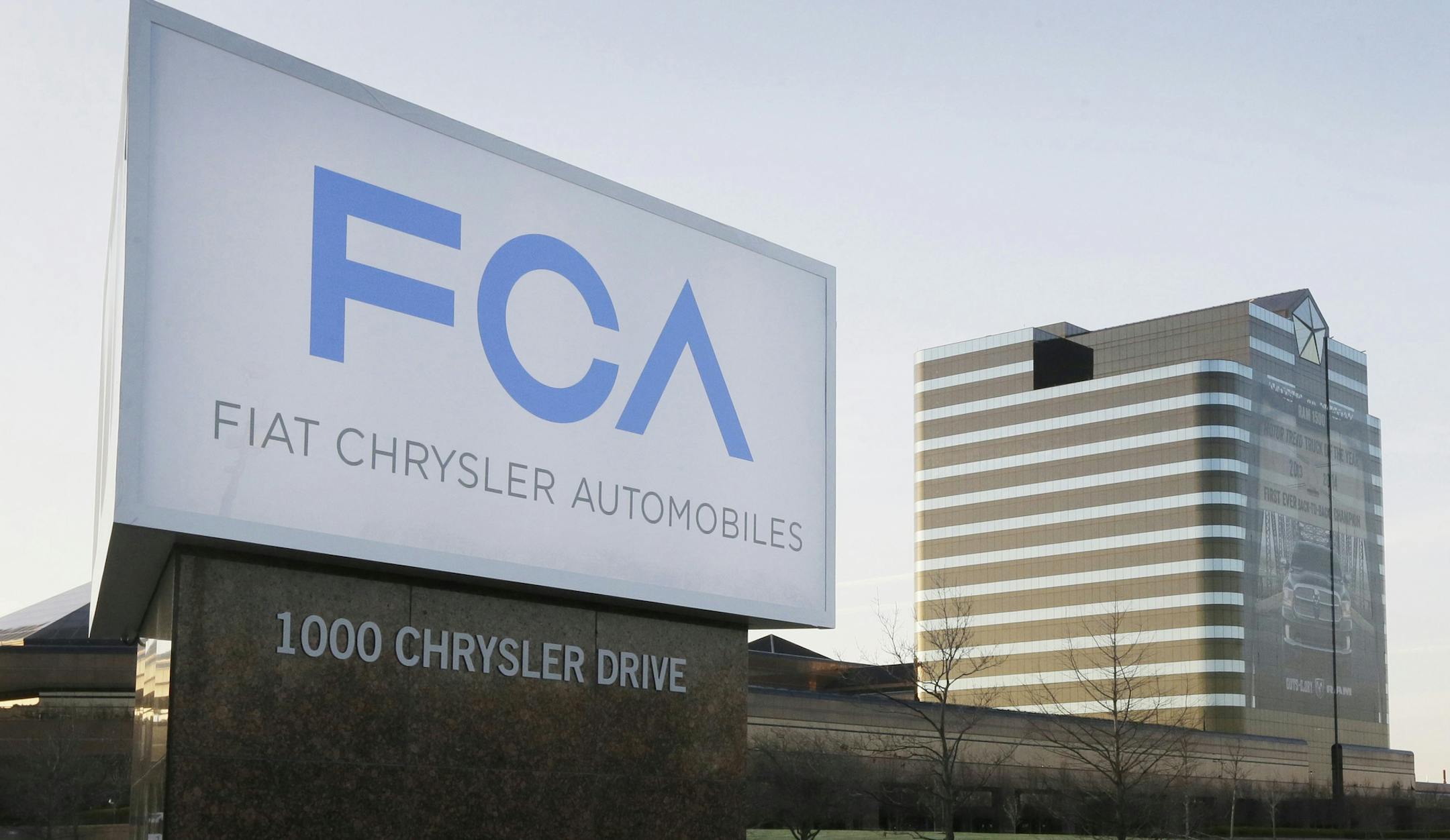 FILE - This Tuesday, May 6, 2014, file photo shows a sign outside Fiat Chrysler Automobiles world headquarters in Auburn Hills, Mich. In a lawsuit filed Tuesday, May 23, 2017, the U.S. government is suing Fiat Chrysler, alleging that some diesel pickup trucks and Jeeps cheat on emissions tests. (AP Photo/Carlos Osorio, File)