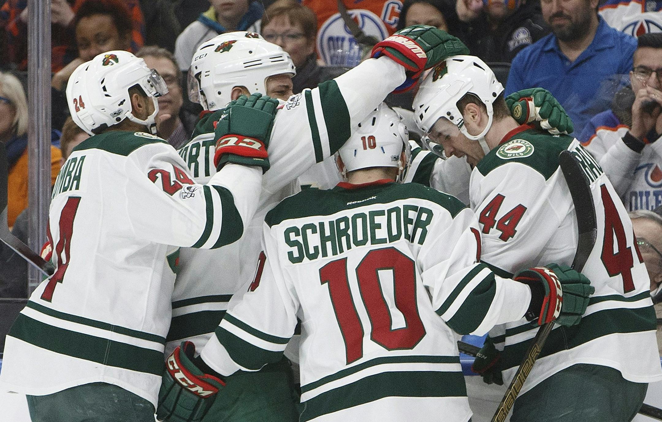 Teammates gathered around Wild center Tyler Graovac (44), who scored Tuesday's first goal.