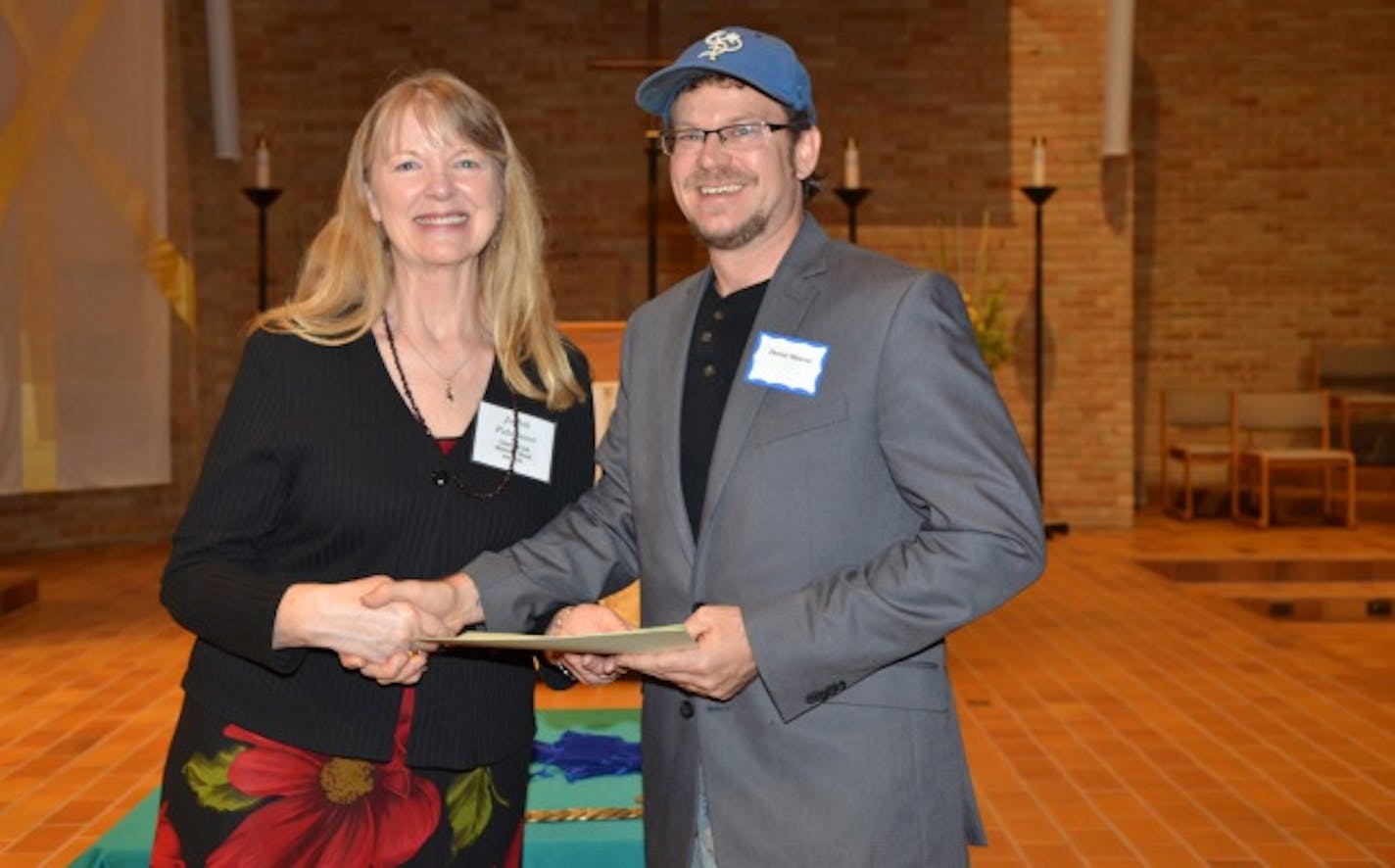 Judith Palmateer, the 2015 Midwest Book Awards chair, congratulates Daniel Maurer, author of Sobriety, A Graphic Novel, a winner in the Self-Help category, at last year's Midwest Book Awards.