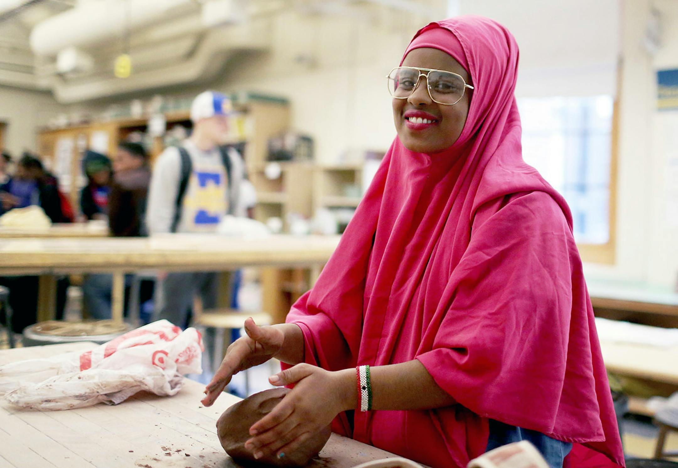 Najmo Said, a Edison High 11th grader, talks about the Empty Bowls fundraiser while wedging clay at Edison High School Thursday, April 13, 2017, in Minneapolis, MN.