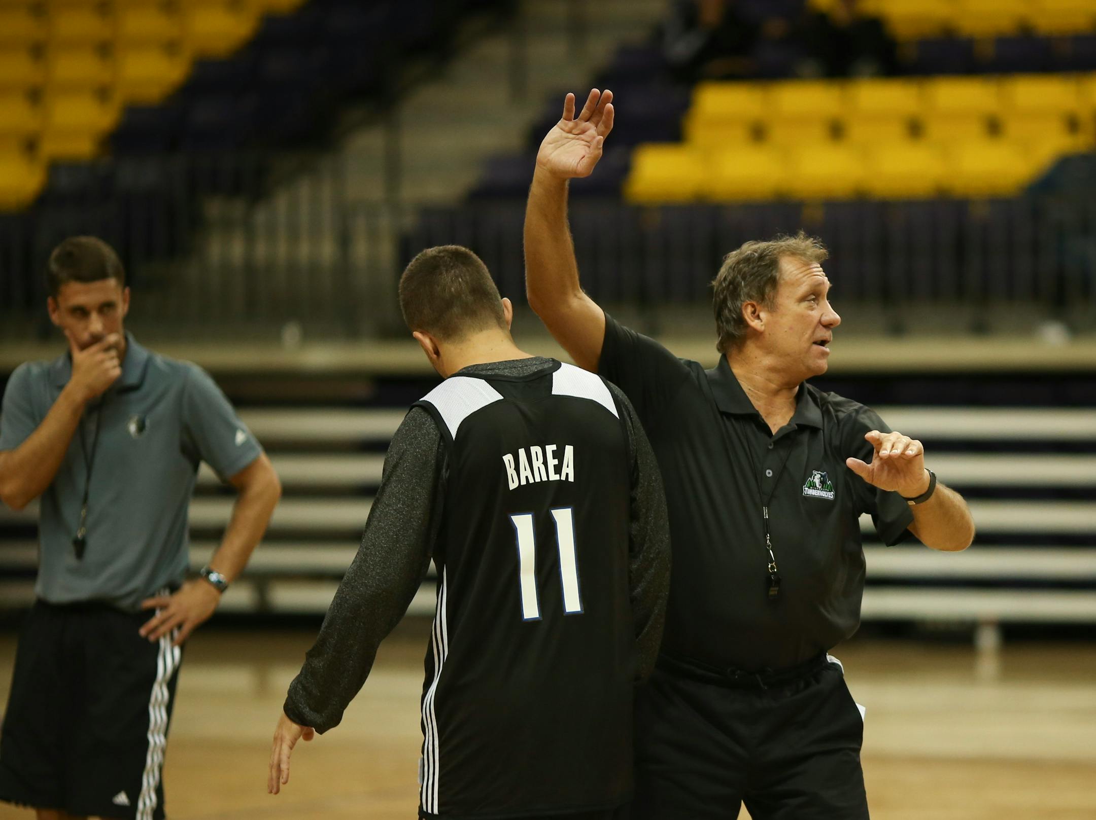 Timberwolves head coach Flip Saunders demonstrated a drill with J.J. Barea during the Timberwolves practice Tuesday afternoon at Bresnan Arena in Taylor Center in Mankato. At left was assistant coach Ryan Saunders, Flip's son. ] JEFF WHEELER • jeff.wheeler@startribune.com After a midnight scrimmage Monday night, the Minnesota Timberwolves worked out Tuesday afternoon, September 29, 2014 at Bresnan Arena in Taylor Center on the campus of Minnesota State University, Mankato.