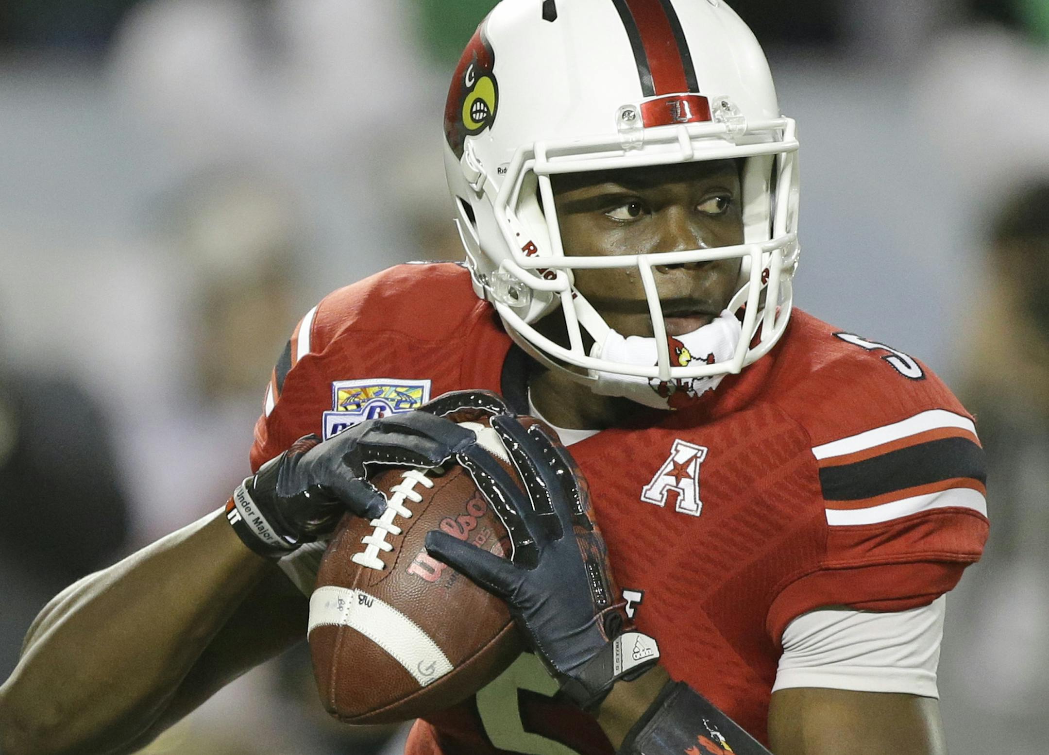 Louisville quarterback Teddy Bridgewater looks for a receiver during the first half of the Russell Athletic Bowl NCAA college football game against Miami in Orlando, Fla., Saturday, Dec. 28, 2013.(AP Photo/John Raoux) ORG XMIT: NYOTK