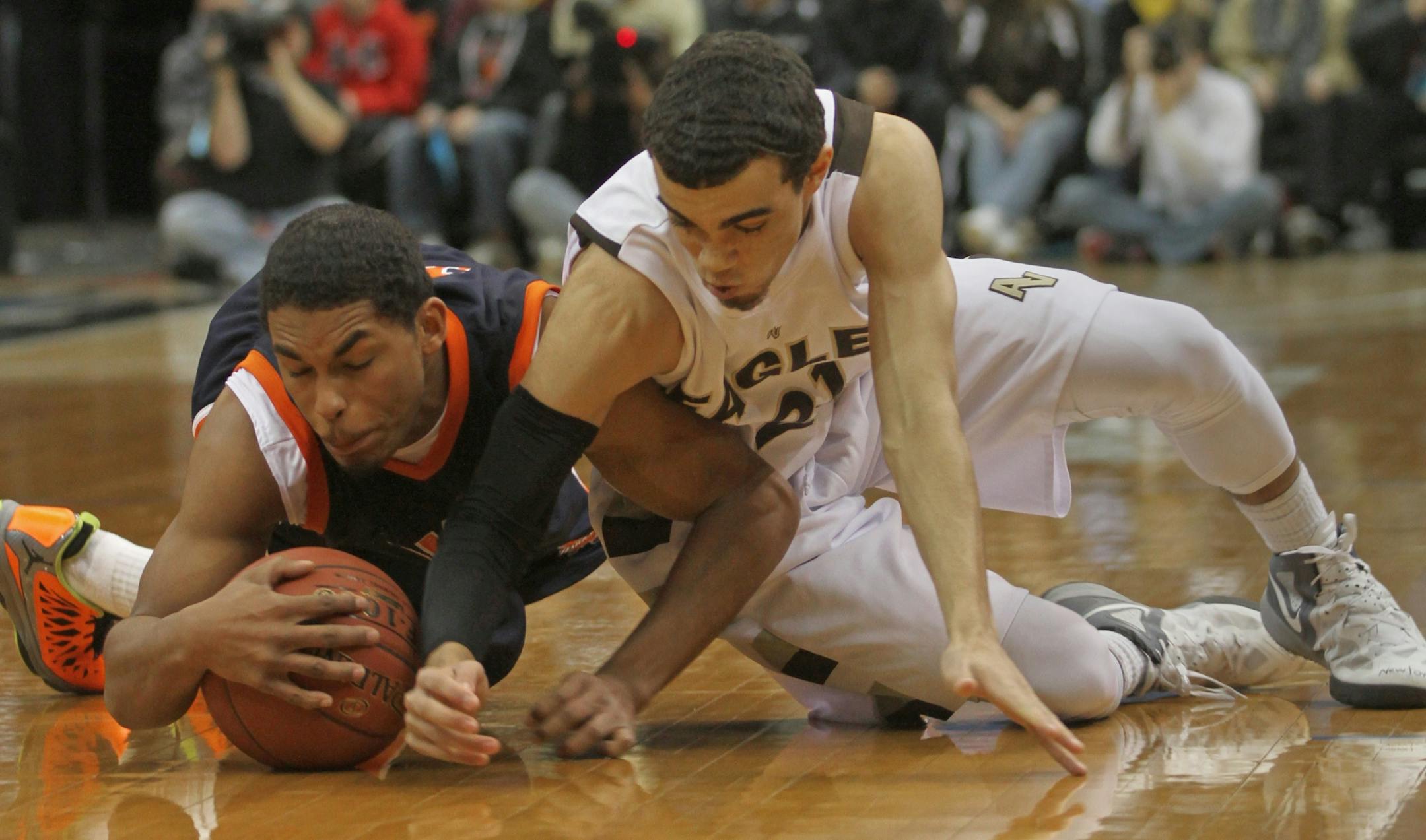 (left to right) Robbinsdale Cooper's Brandon Baker and Apple Valley's Tyus Jones dove for the ball during the 2013 Minnesota Timberwolves Shootout at the Target Center on 1/5/13.