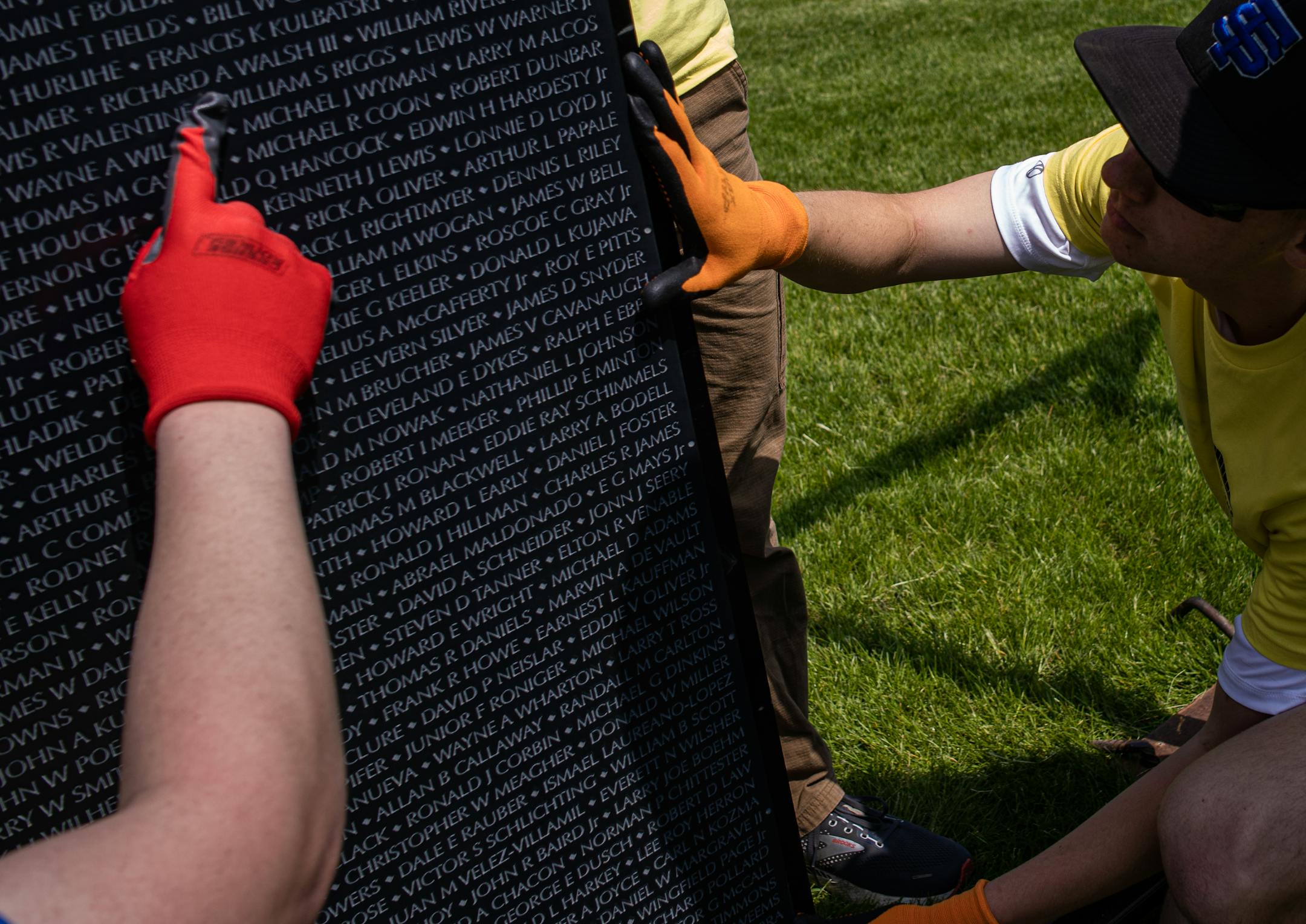 St. Thomas Academy cadets, including future West Point cadet Eric Zauha, help assemble a 3/4 scale of the Wall That Heals that contains 58,281 names of Vietnam Veterans who died in combat including Richard Walsh III on this panel.