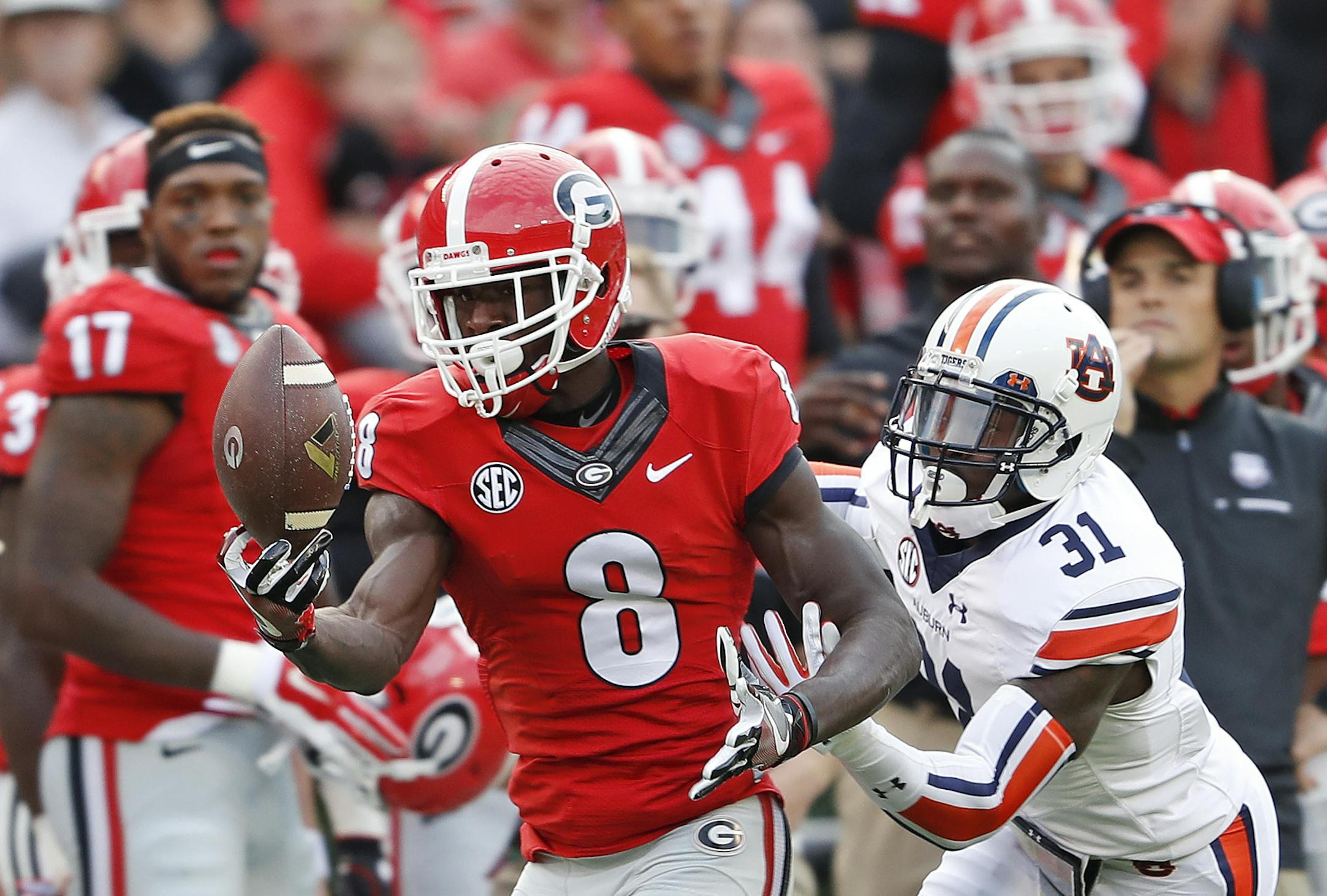 Georgia wide receiver Riley Ridley (8) makes a catch as Auburn defensive back Javaris Davis (31) defends in the first half of an NCAA college football game Saturday, Nov. 12, 2016, in Athens, Ga. (AP Photo/John Bazemore)