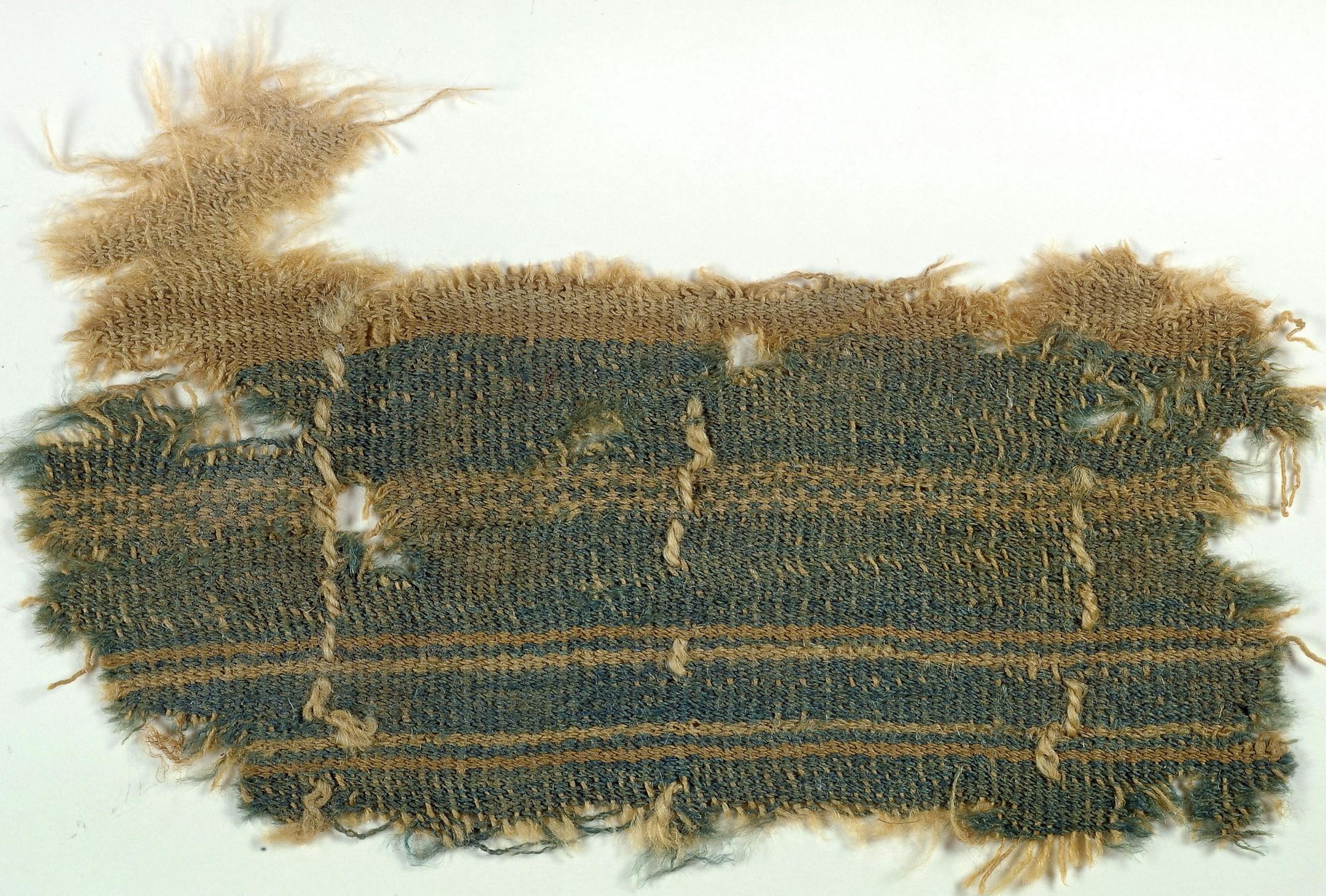 This undated photograph released by the Israelís Antiquities Authority Tuesday, Dec. 31, 2013, shows a nearly 2,000-year old textile that appears to contain a mysterious blue color described in the Bible, one of the few remnants of the ancient color ever discovered. Researchers and rabbis have long searched for the enigmatic color, called tekhelet in Hebrew. The Bible commands Jews to wear a blue fringe on their garments, but the dye was lost in antiquity. (AP Photo/Clara Amit, Israel Antiq