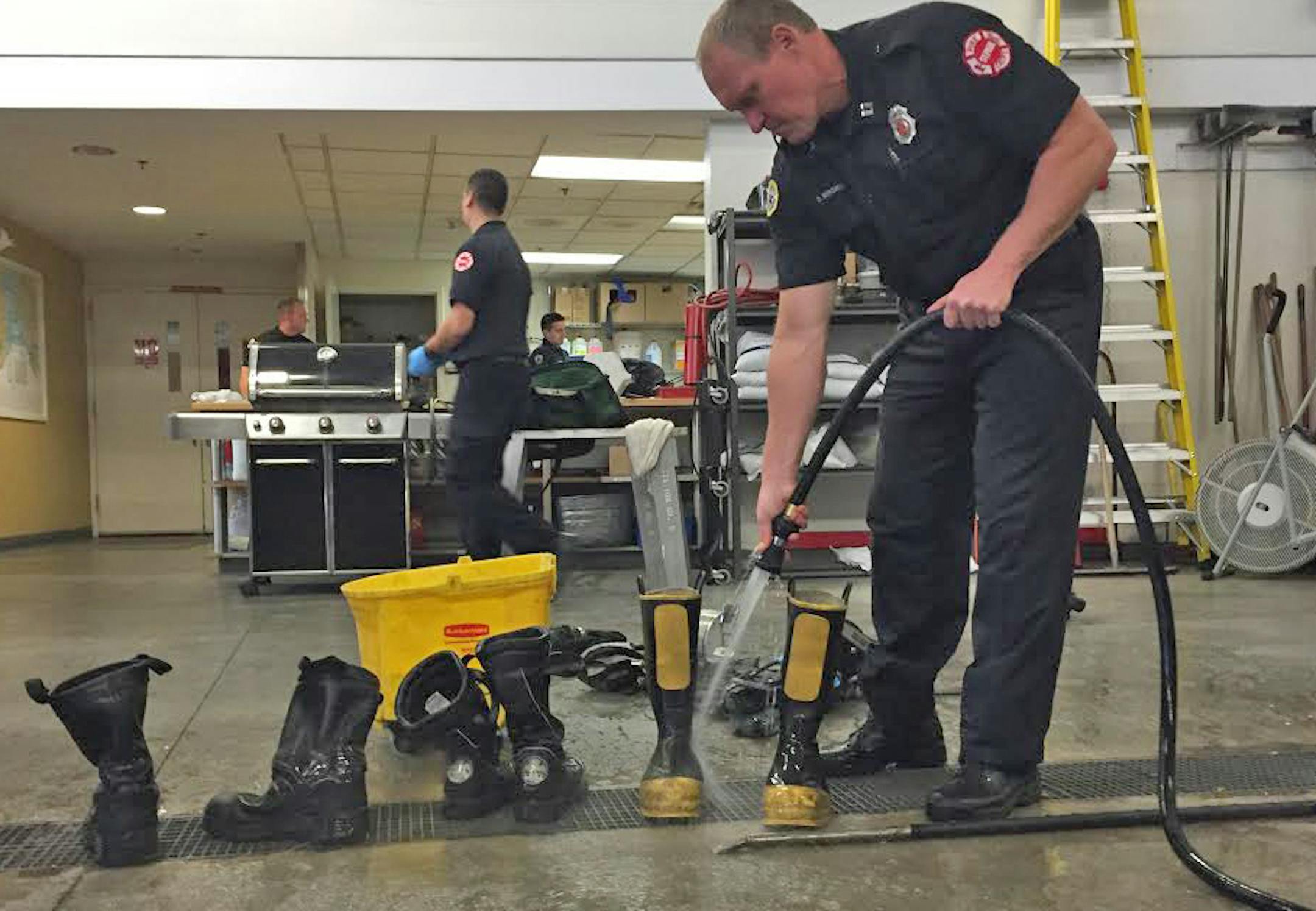St. Paul Fire Department staff scrubbed gear and washed protective clothing after a house fire Tuesday. The Twin Cities are emphasizing the importance of clean gear as they seek to prevent cancer among firefighters. ] Photo credit: Jessie Van Berkel Star Tribune St. Paul, MN