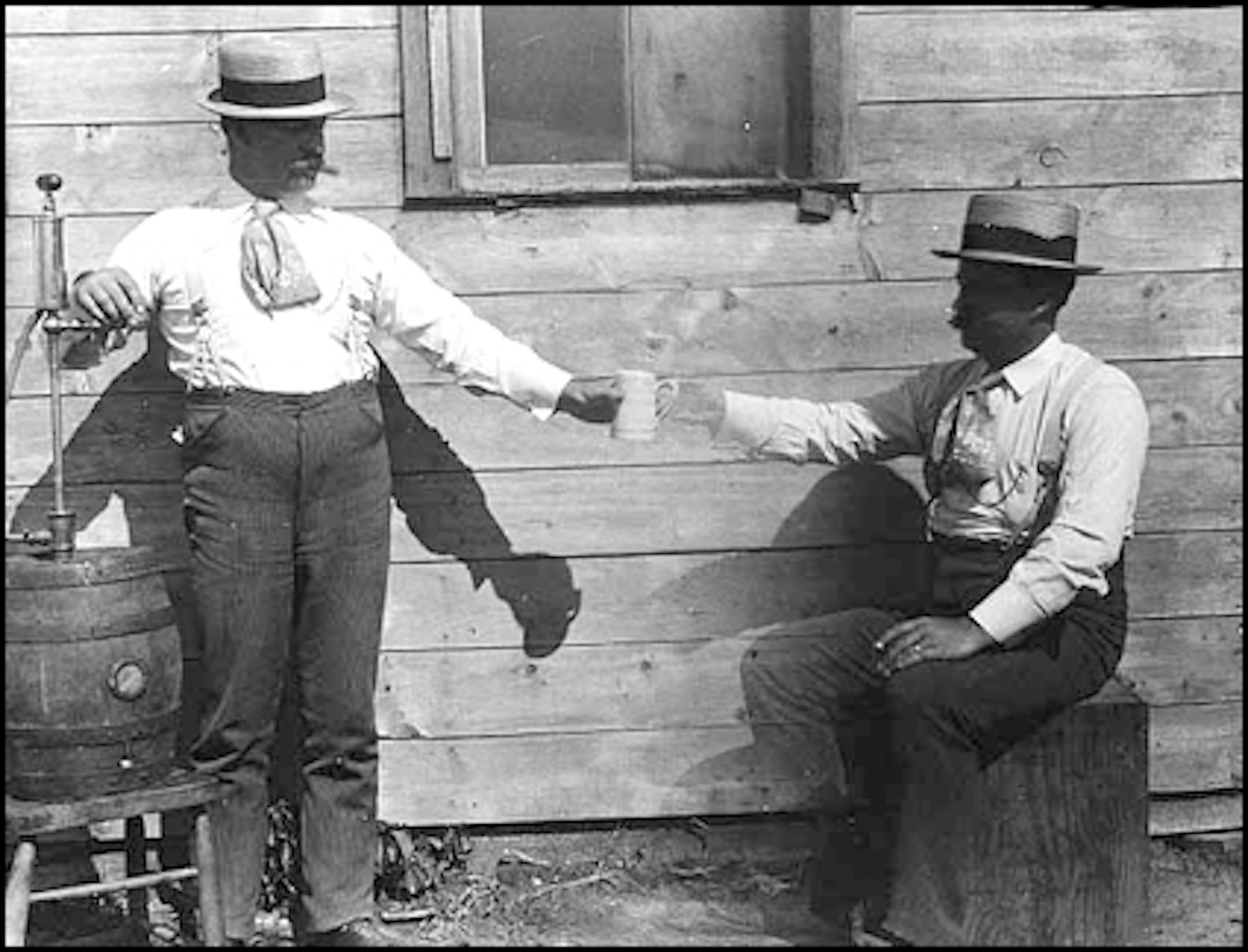 Drinking beer from a wooden keg (two figures in the photo are the same man).
