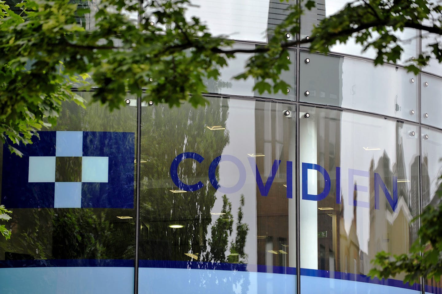 A Covidien logo sits on the glass windows of medical device manufacturer Covidien Plc's head office in Dublin, Ireland, on Monday, June 16, 2014. Medtronic Inc., the second-largest maker of medical devices, agreed to buy Covidien for $42.9 billion in cash and stock as it transforms into a broader-based company bolstered by new tax advantages. Photographer: Aidan Crawley/Bloomberg ORG XMIT: 498097627