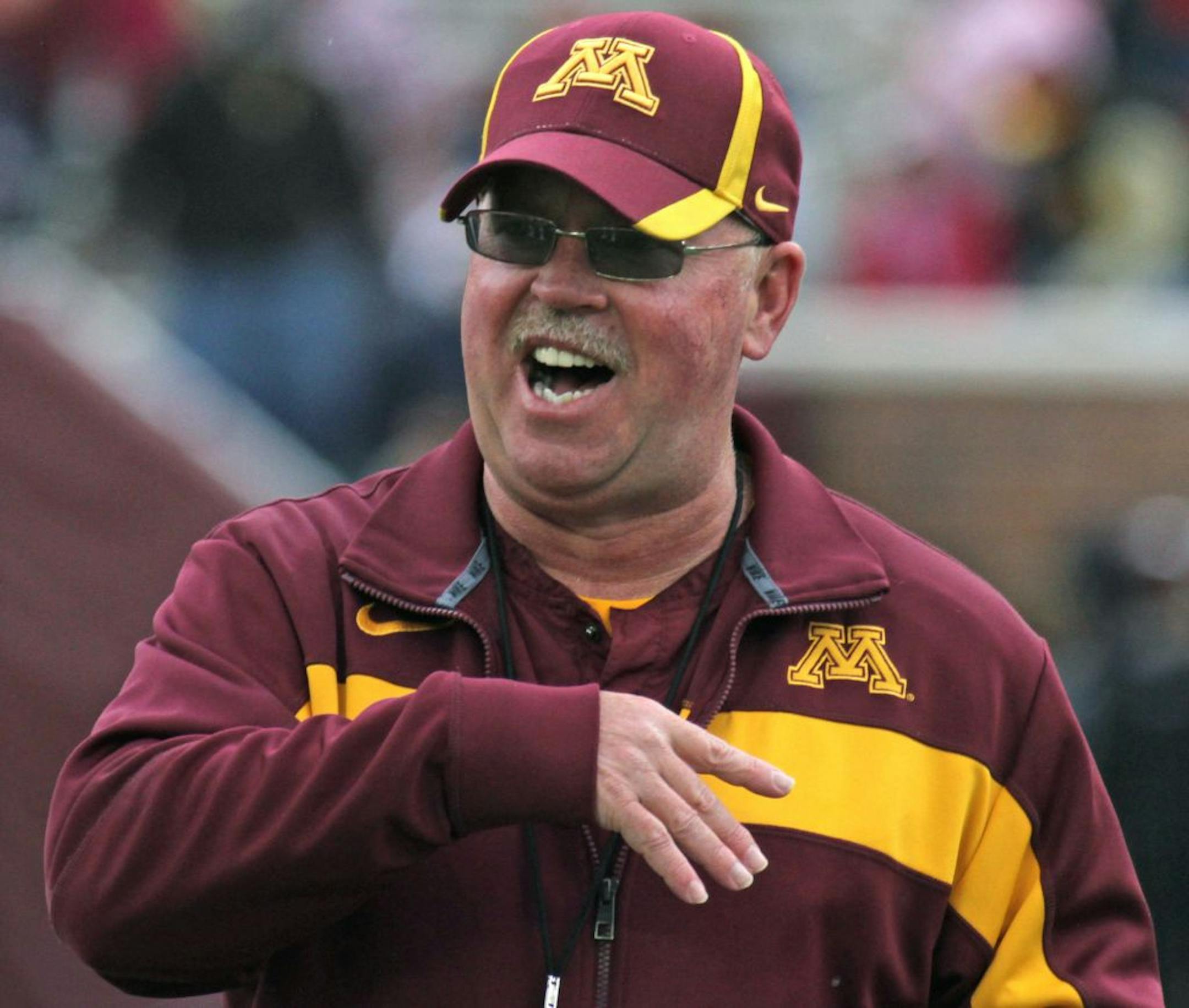 Gopher Head Football Coach Jerry Kill talked with players near the end of the game, as the Gophers wrapped up spring football practice with the spring game at TCF Bank Stadium on 4/21/12.