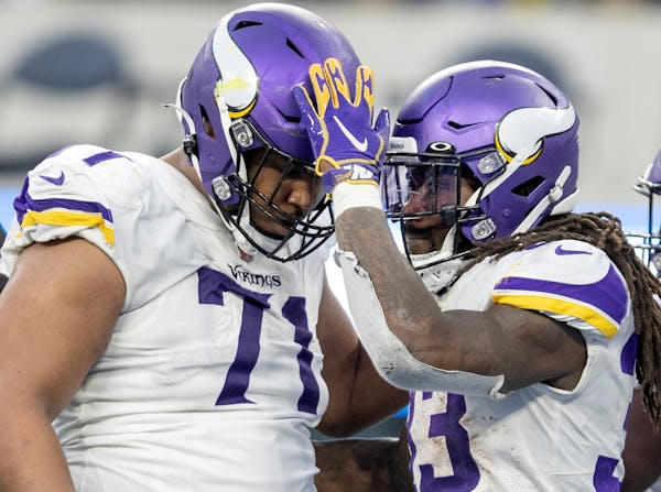 Christian Darrisaw (71) and Dalvin Cook (33) of the Minnesota Vikings celebrates a Cook touchdown in the fourth quarter Sunday, Nov. 14, 2021 at SoFi 