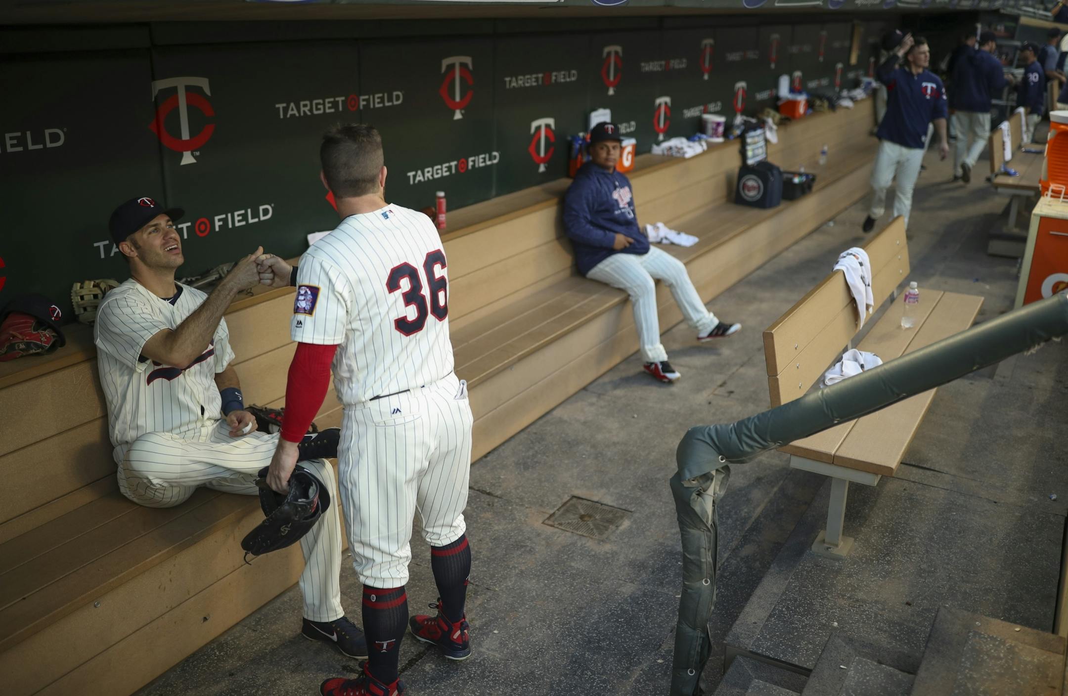 Minnesota Twins first baseman Joe Mauer (7) fist bumped left fielder Robbie Grossman (36) before the start of Wednesday night's game against the Yankees.