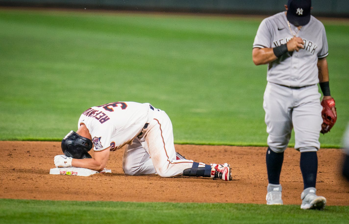 Minnesota Twins' Rob Refsnyder reacts at second base after suffering an injury while hitting a double against the New York Yankees during the sixth inning of a baseball game Tuesday, June 8, 2021, in Minneapolis. (Leila Navidi/Star Tribune via AP)