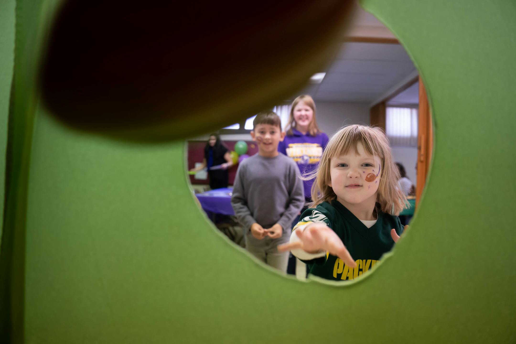 Lillian Vanderberg, 4, drilled three straight nerf footballs through a hole to win a prize.