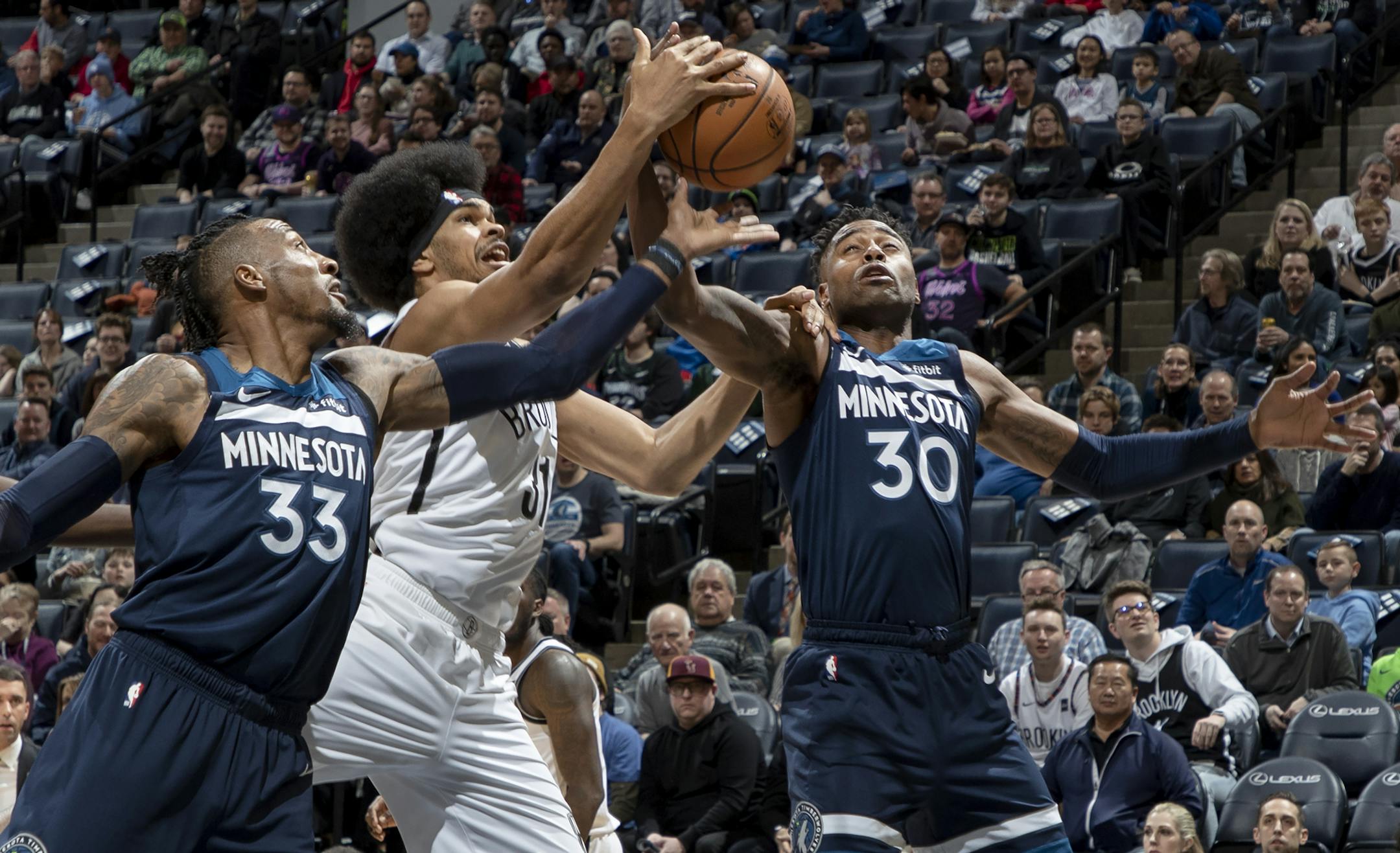 Jarrett Allen (31) on the Brooklyn Nets fought for the ball with Robert Covington (33) and Kelan Martin (30) of the Minnesota Timberwolves in the first quarter. ] CARLOS GONZALEZ • cgonzalez@startribune.com – Minneapolis, MN – December 30, 2019, Target Center, NBA, Minnesota Timberwolves vs. Brooklyn Nets